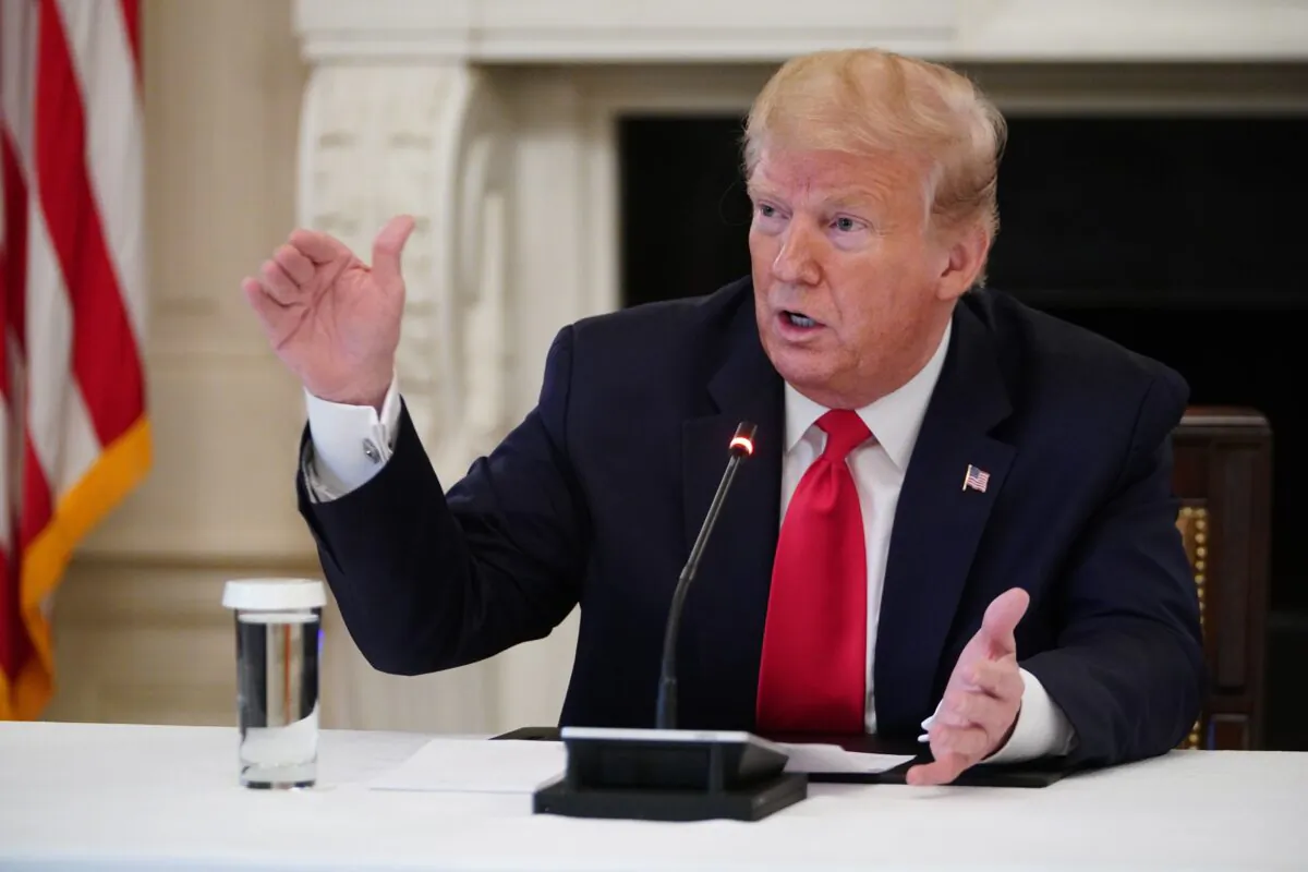 U.S. President Donald Trump takes part in a roundtable discussion with industry executives on Opening Up America Again in the State Dining Room of the White House in Washington on April 29, 2020. (MANDEL NGAN/AFP via Getty Images)