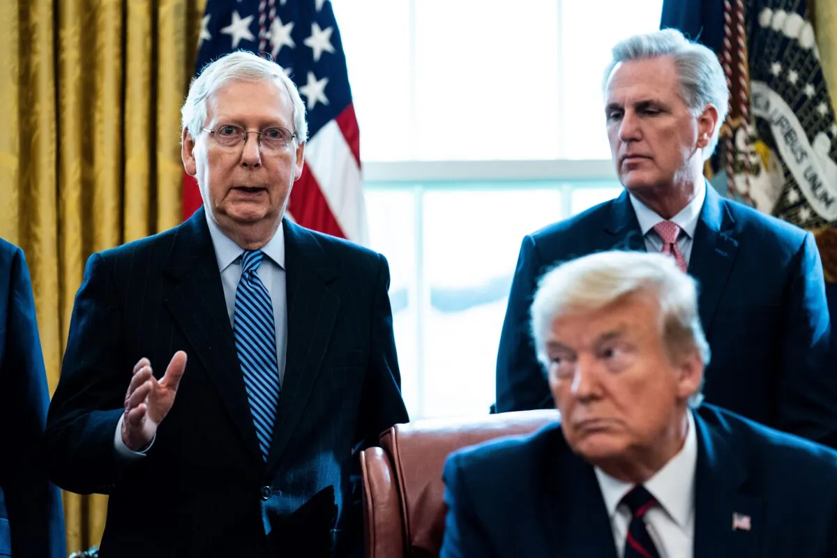 Senate GOP Leader Mitch McConnell (R-Ky.) speaks as House Minority Leader Kevin McCarthy (R-Calif.) and then-President Donald Trump listen during a signing ceremony for H.R. 748, the CARES Act in the Oval Office of the White House in Washington on March 27, 2020. (Erin Schaff-Pool/Getty Images)