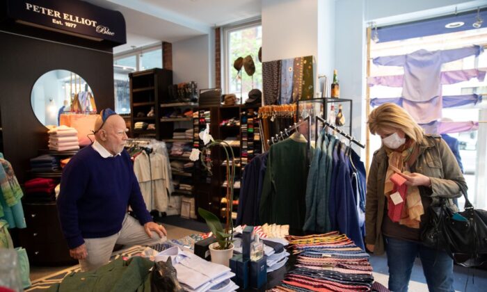 A customer shops at Peter Elliot boutique in New York City on April 29, 2020. Eliot Rabin, the owner of the boutique (L) is keeping his store open because he objects to the state order deeming his business non-essential, and says he has received widespread support for his stance. (Jeenah Moon/Getty Images)