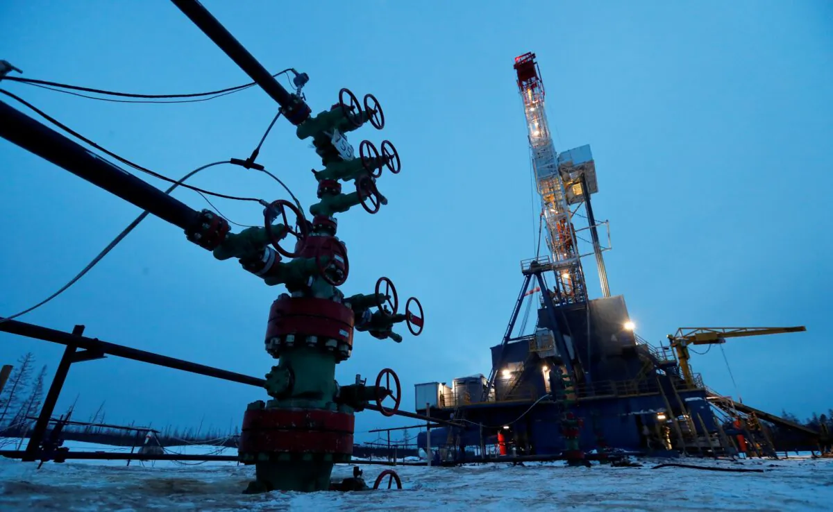 A well head and a drilling rig in the Yarakta Oil Field, owned by Irkutsk Oil Company (INK), in Irkutsk Region, Russia, on March 11, 2019. (Vasily Fedosenko/Reuters) 