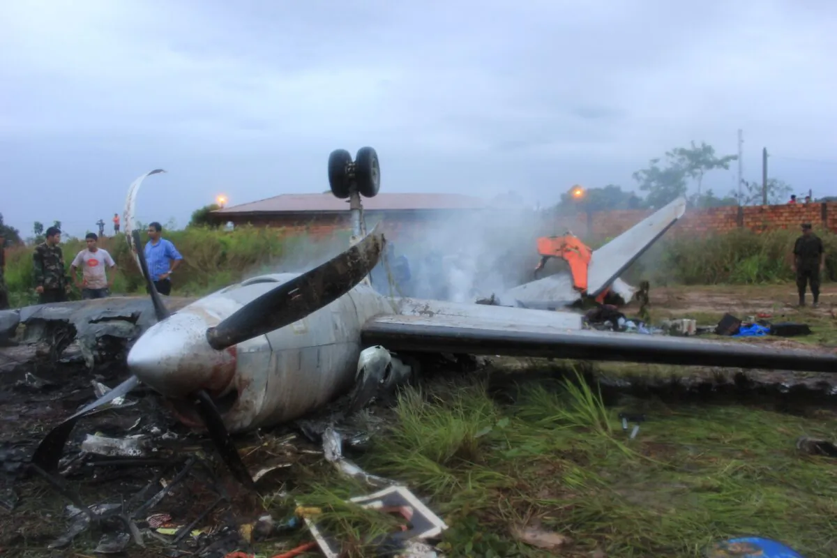 The wreckage of an Aerocon airlines Fairchild Metro 23 turboprop aircraft that crashed on landing in Riberalta, northern Bolivia, near the Brazilian border, leaving eight passengers dead and 10 injured, on Nov. 3, 2013. (Photo STR/AFP via Getty Images)