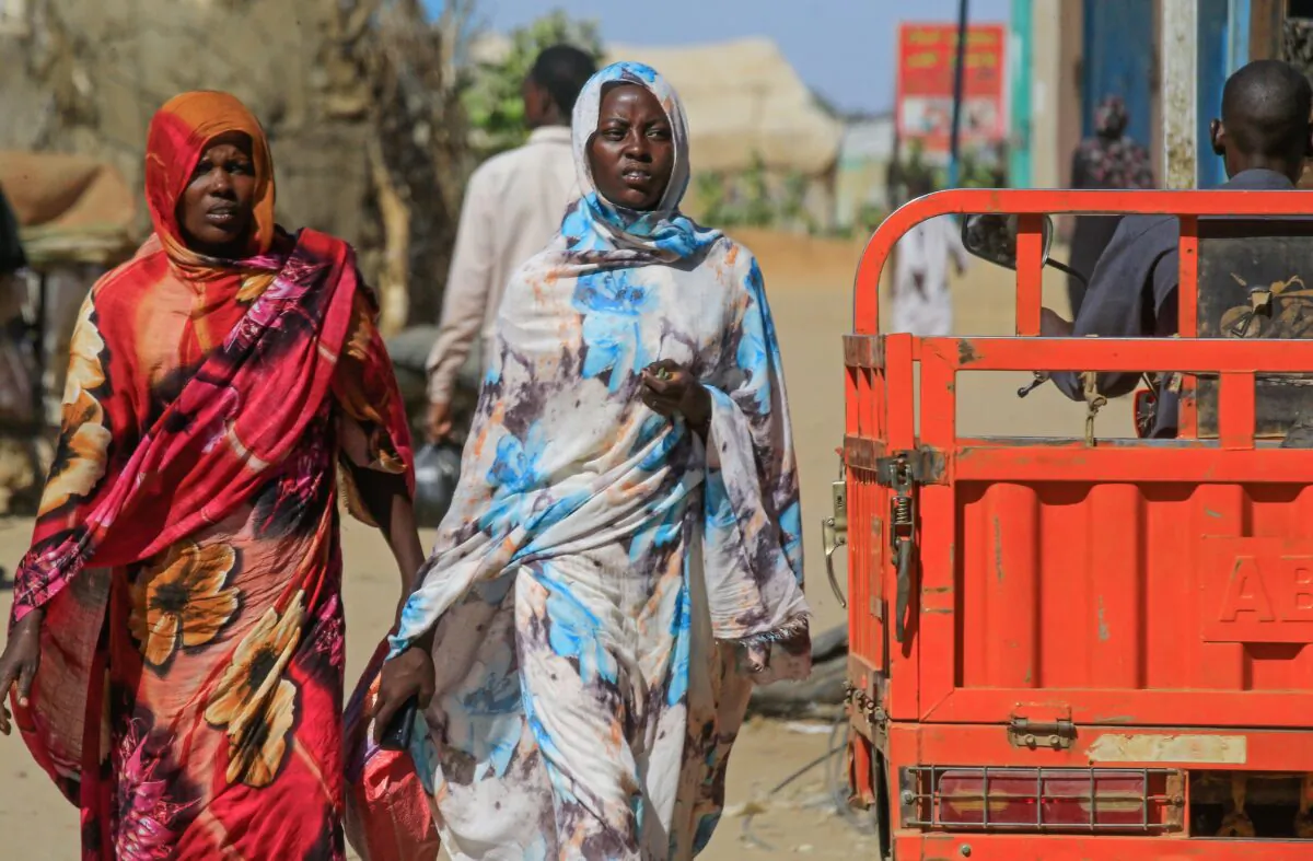 Sudanese women walk to a market in Abu Shouk camp, nearly 20 kms north of El-Fasher, the capital of the North Darfur state, on Nov. 5, 2019. (Ashraf Shazly/AFP via Getty Images)