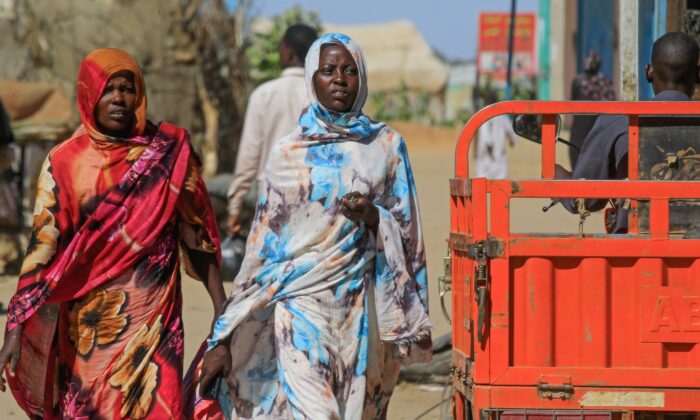 Sudanese women walk to a market in Abu Shouk camp, nearly 20 kms north of El-Fasher, the capital of the North Darfur state, on Nov. 5, 2019. (Ashraf Shazly/AFP via Getty Images)