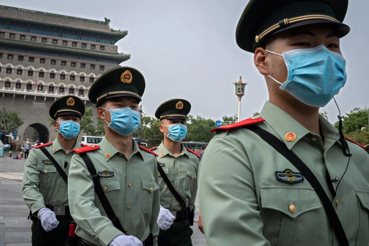 Paramilitary police officers patrol near Beijing's Tiananmen Square (not pictured) on World Press Freedom Day on May 3, 2020. (Nicolas Asfouri/AFP via Getty Images)