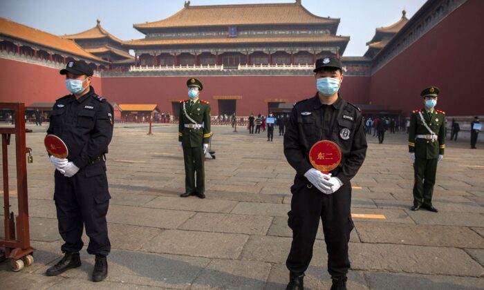 Chinese paramilitary police and security officers stand guard outside an entrance to the Forbidden City in Beijing on May 1, 2020. (Mark Schiefelbein/AP Photo)