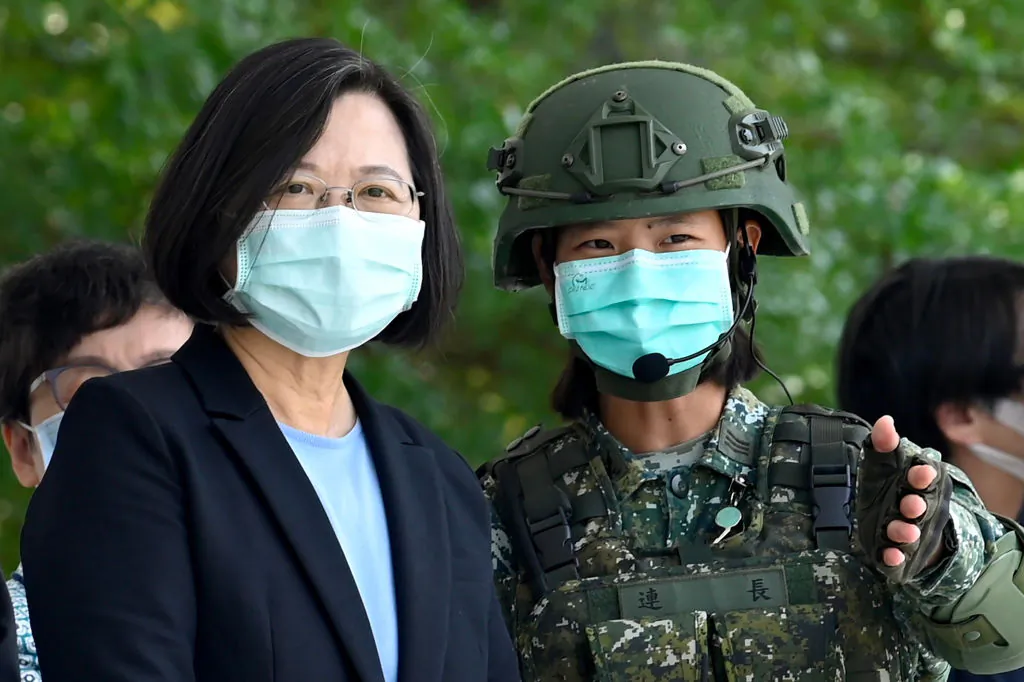 Taiwan President Tsai Ing-wen (L) listens to a masked soldier amid the coronavirus pandemic during her visit to a military base in Tainan, southern Taiwan, on April 9, 2020. (Sam Yeh/AFP via Getty Images)