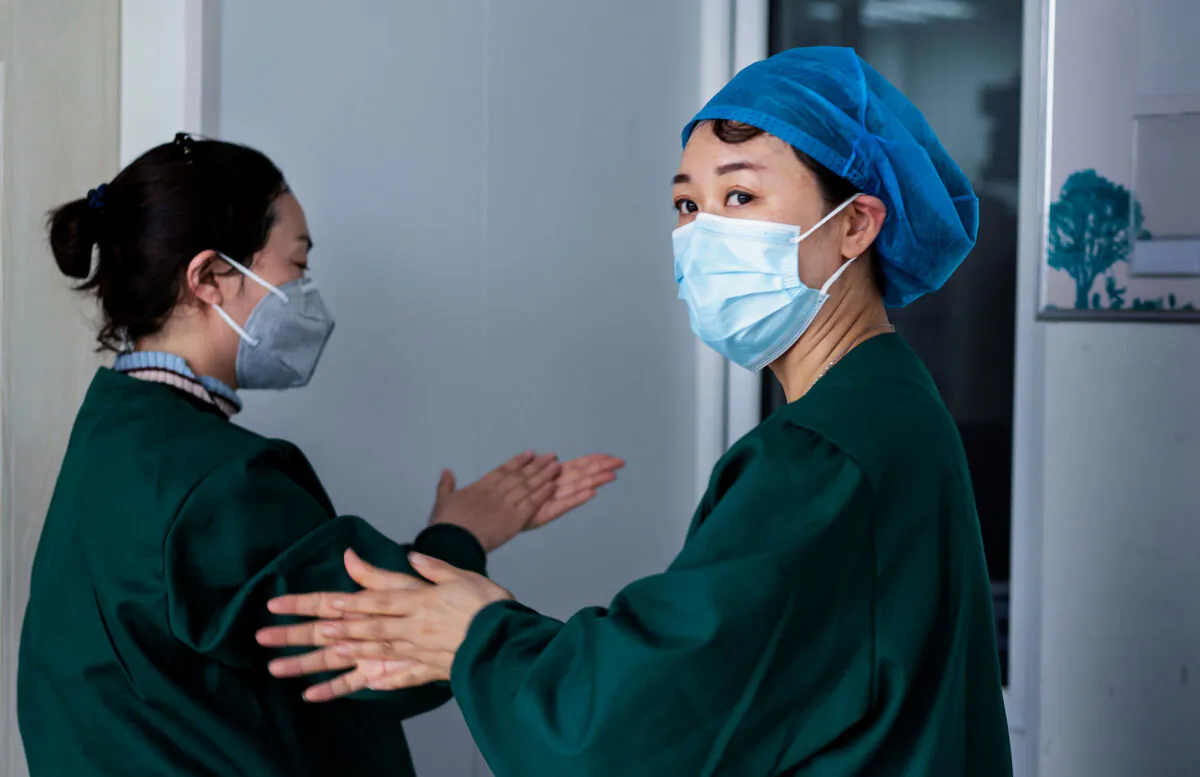Medical personnel are working on nucleic acid testing as part of CCP virus pandemic measures, at a health services centre in Suifenhe in China's northeastern Heilongjiang province on April 24, 2020. (STR/AFP via Getty Images)