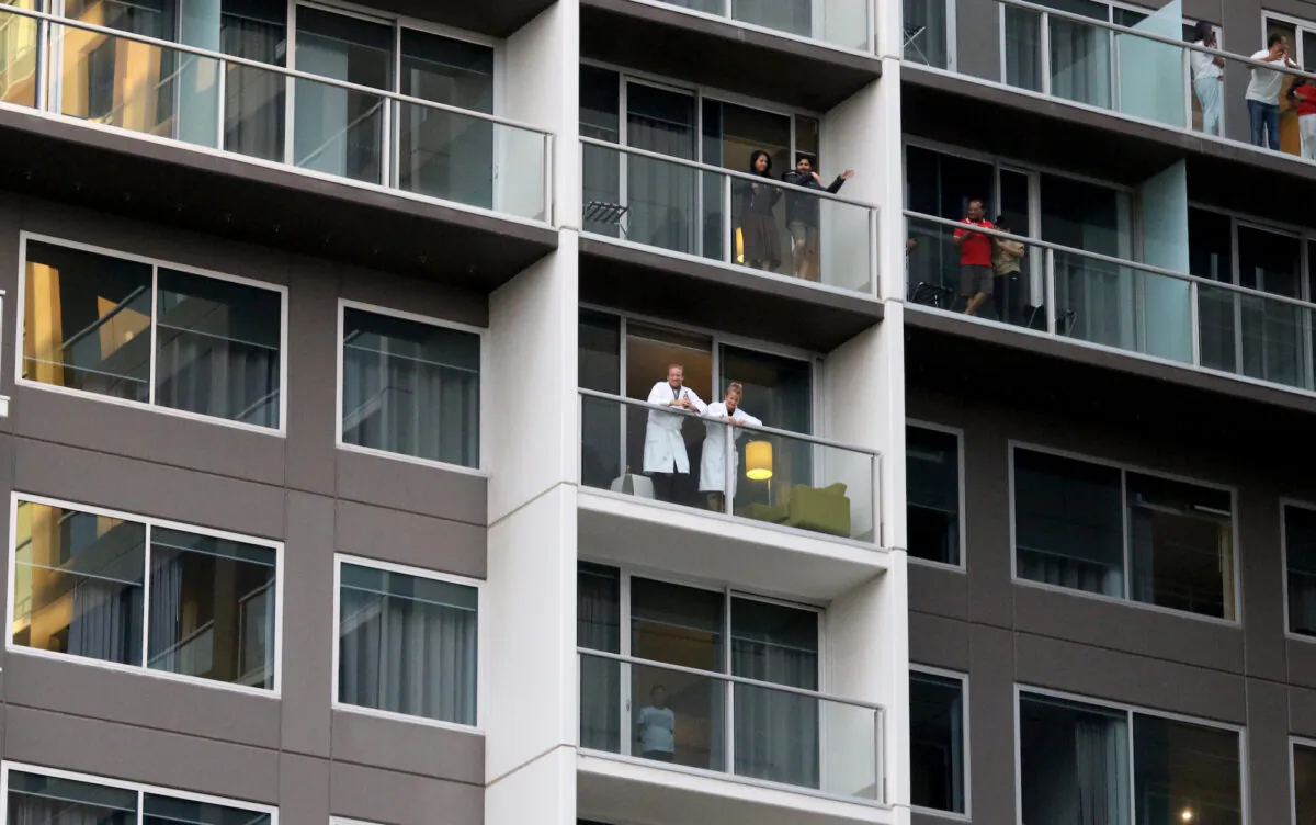 Guests on the balconies of the Pullman watching Adelaide cabaret performer Hans performs in Adelaide, Australia, on May 3, 2020. (Kelly Barnes/Getty Images)