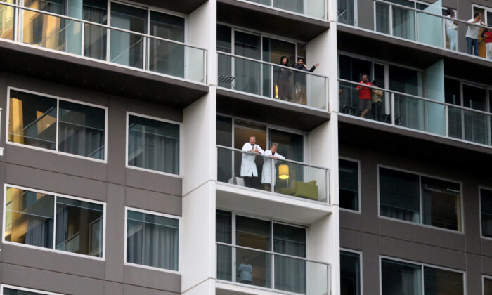 Guests on the balconies of the Pullman watching Adelaide cabaret performer Hans performs in Adelaide, Australia, on May 3, 2020. (Kelly Barnes/Getty Images)