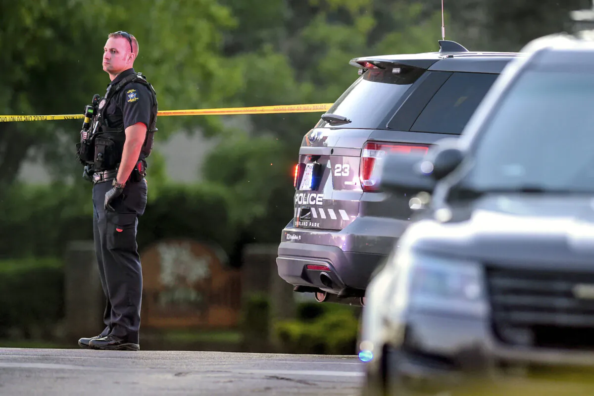 A policeman looks over the scene where police in Kansas say a shootout has left both a police officer and a hit-and-run suspect dead, in Overland Park, Kan., on May 3, 2020. (Tammy Ljungblad/The Kansas City Star via AP)
