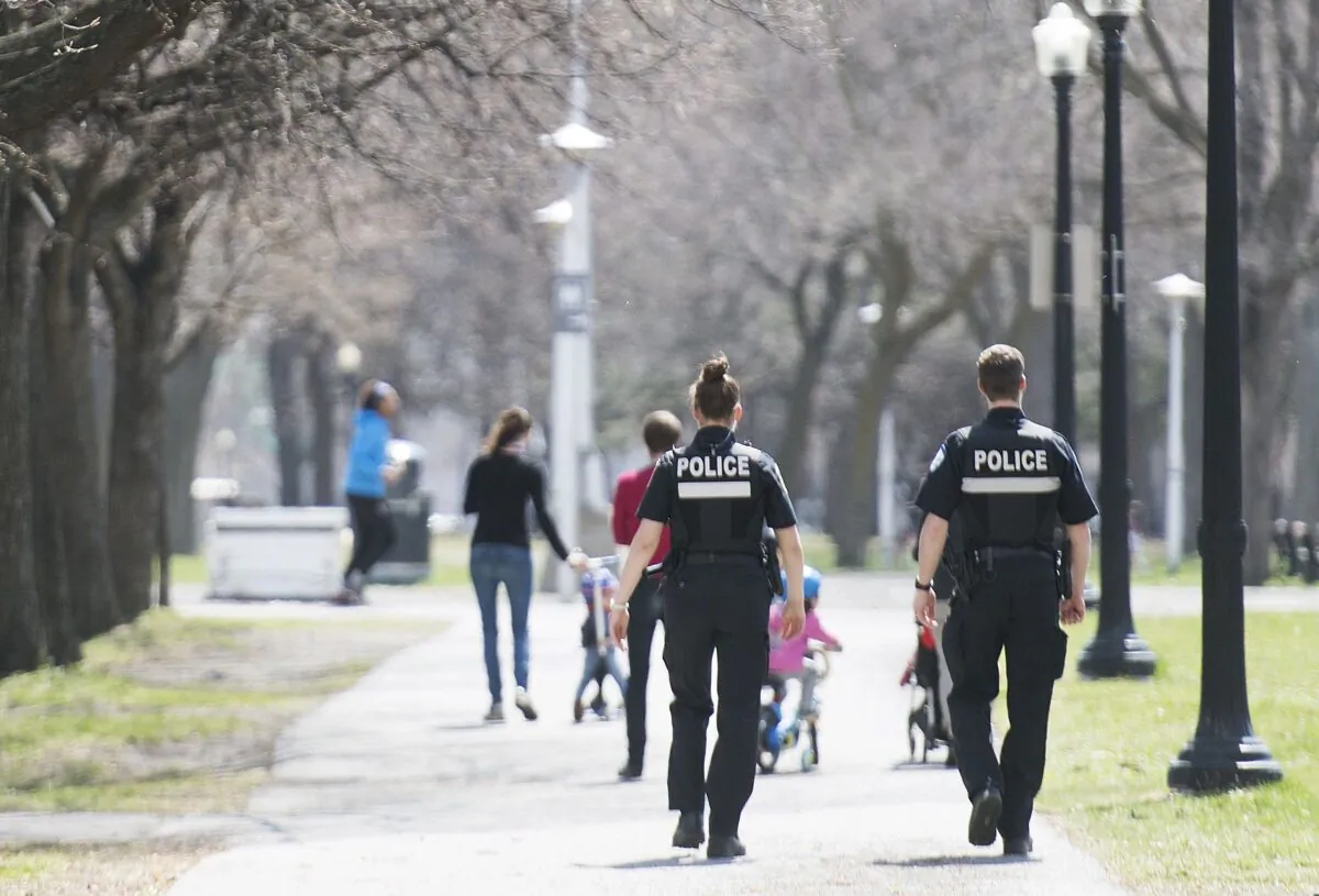Police officers patrol a city park in Montreal on May 3, 2020, as the COVID-19 pandemic continues. (Graham Hughes/The Canadian Press)