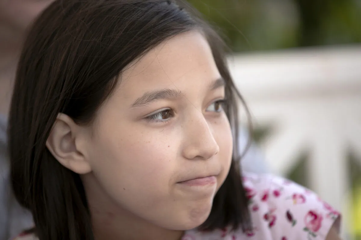 Juliet Daly, 12, sits on the front porch of their family home in Covington, La., on April 30, 2020. (Gerald Herbert/ AP Photo) 