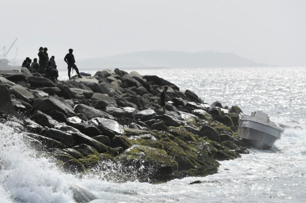 Security forces guard the shore area and a boat