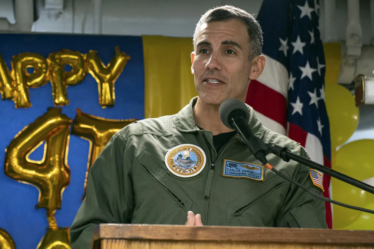 U.S. Navy, Capt. Carlos Sardiello, who was then the commanding officer of the aircraft carrier USS Theodore Roosevelt (CVN 71), addresses sailors during the 244th Navy birthday celebration on the mess decks during a home port visit in San Diego, Oct. 15, 2019. (Petty Officer 3rd Class Zachary Wheeler/U.S. Navy/AP)