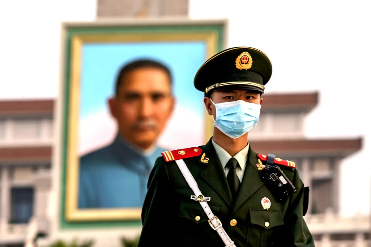 A Chinese police wearing protective masks march in front of the portrait of Nationalist founder Sun Yat-sen at Tiananmen Square in Beijing, China, on April 28, 2020. (Lintao Zhang/Getty Images)