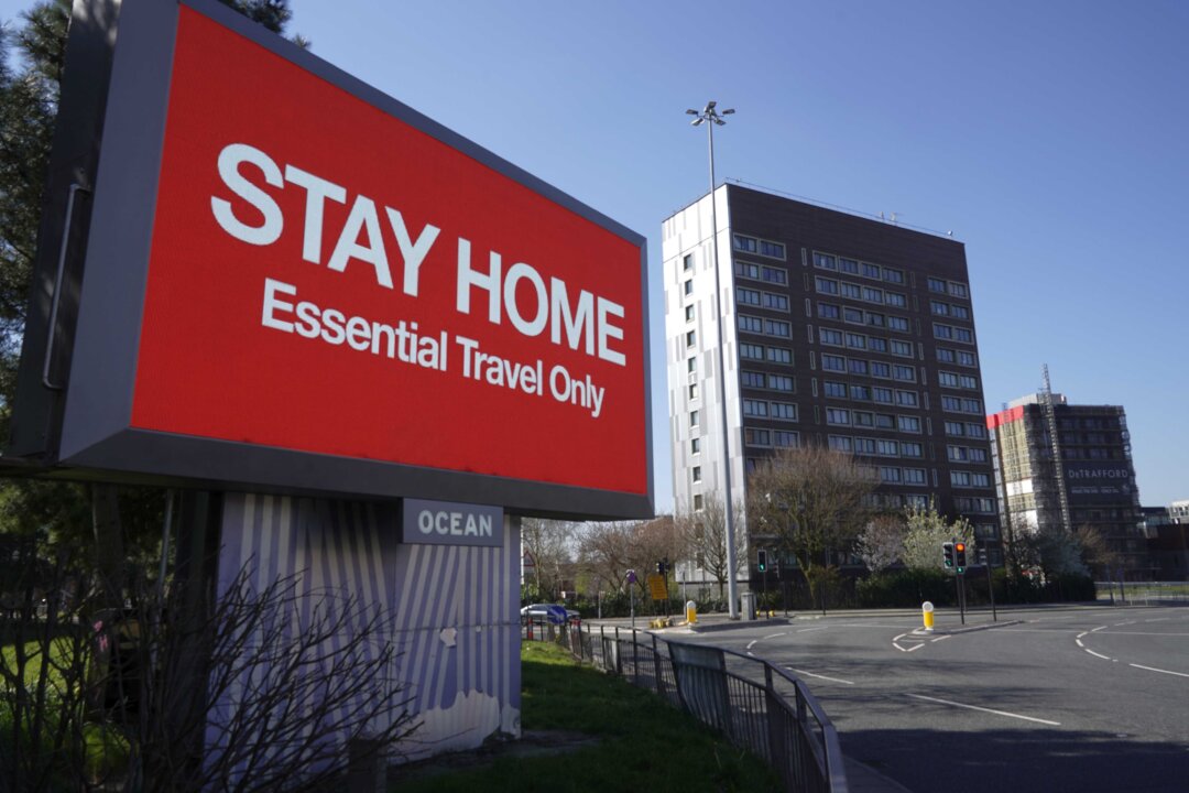 A giant television over the A57 motorway urges people to stay home in Manchester, England, on March 26, 2020. (Christopher Furlong/Getty Images)