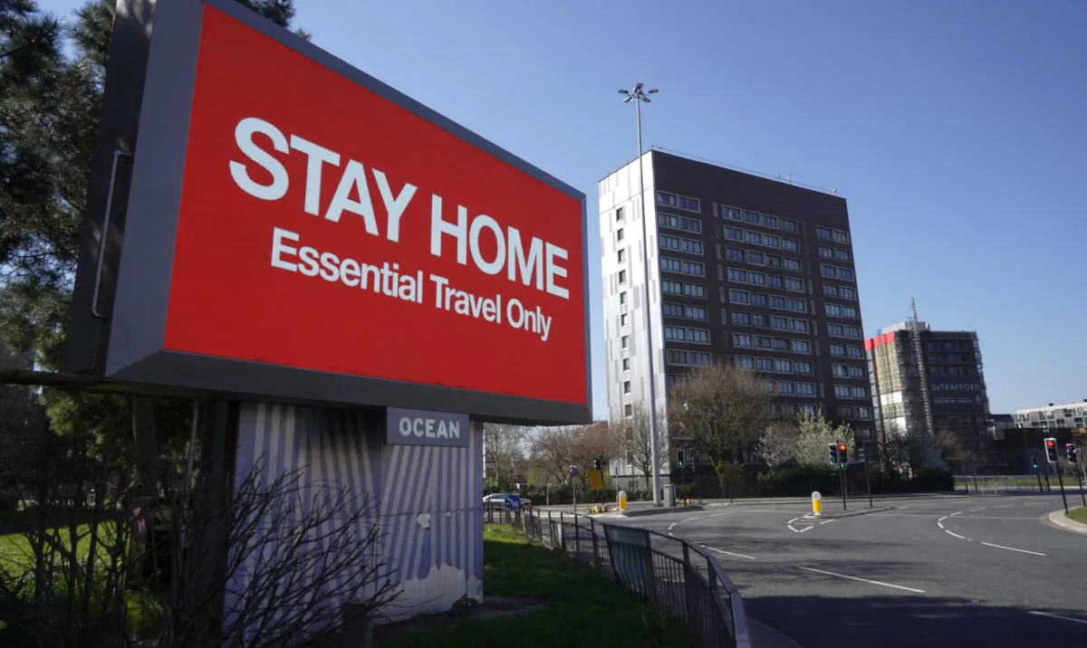 A giant television over the A57 Motorway urges people to stay home during the first national lockdown at the start of the pandemic in Manchester, England, on March 26, 2020. (Christopher Furlong/Getty Images)