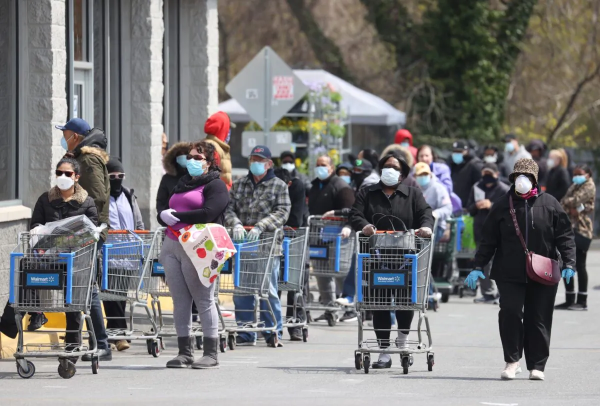 People wearing masks and gloves wait to enter a Walmart in Uniondale, N.Y., on April 17, 2020. (Al Bello/Getty Images)