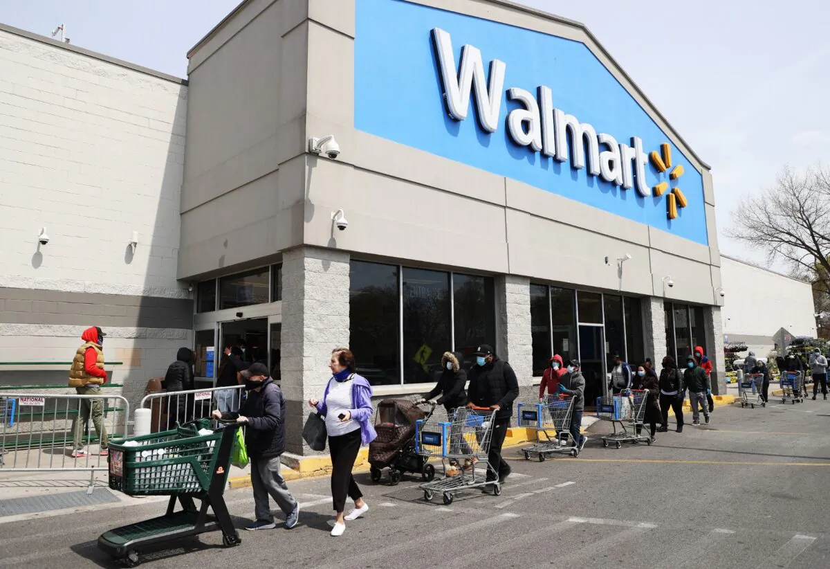 People wear masks and gloves as they wait to enter a Walmart in Uniondale, N.Y., on April 17, 2020. (Al Bello/Getty Images)