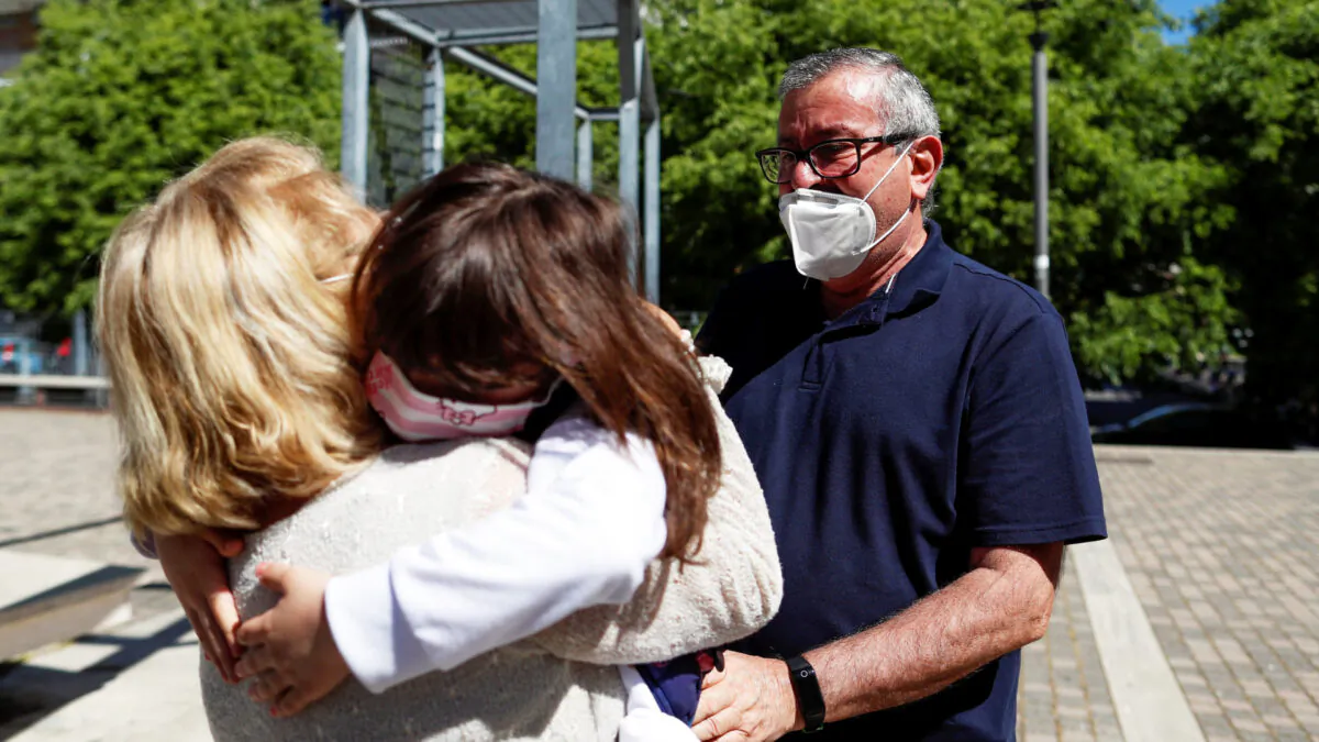 Domenico di Massa and Mariantonia Gangemi embrace their granddaughter Cecilia for the first time in two months after Italy allowed families to see each other again as the country begins a staged end to a nationwide lockdown due to a spread of the coronavirus disease (COVID-19), in Rome, Italy, May 4, 2020. (Yara Nardi/Reuters)
