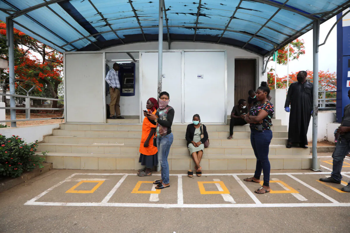 People wait within markings to use the ATM, as authorities ease a lockdown following a COVID-19 outbreak, in Abuja, Nigeria, May 4, 2020. (Afolabi Sotunde/Reuters)