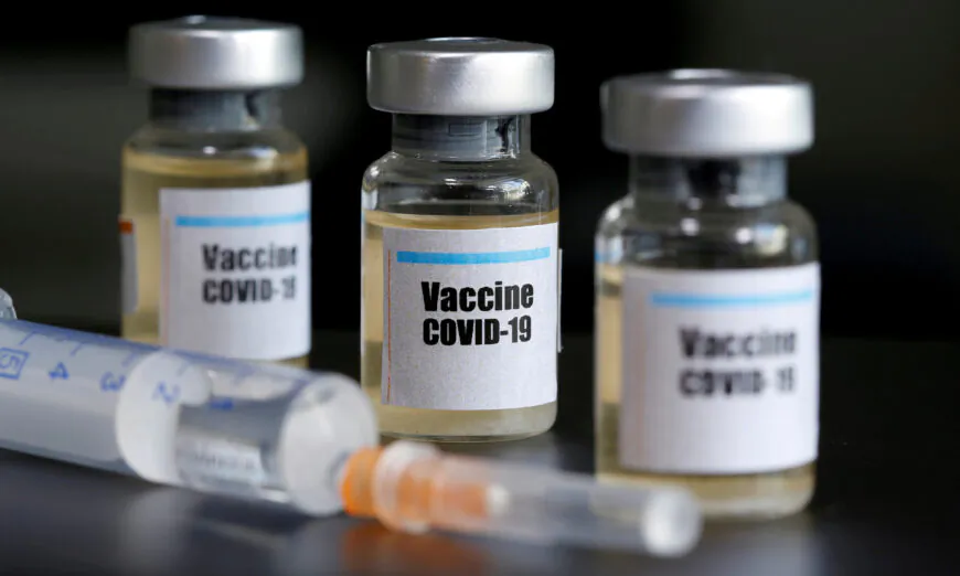 Small bottles labeled with a "Vaccine COVID-19" sticker and a medical syringe are seen in this illustration on April 10, 2020. (Dado Ruvic/Illustration/Reuters)
