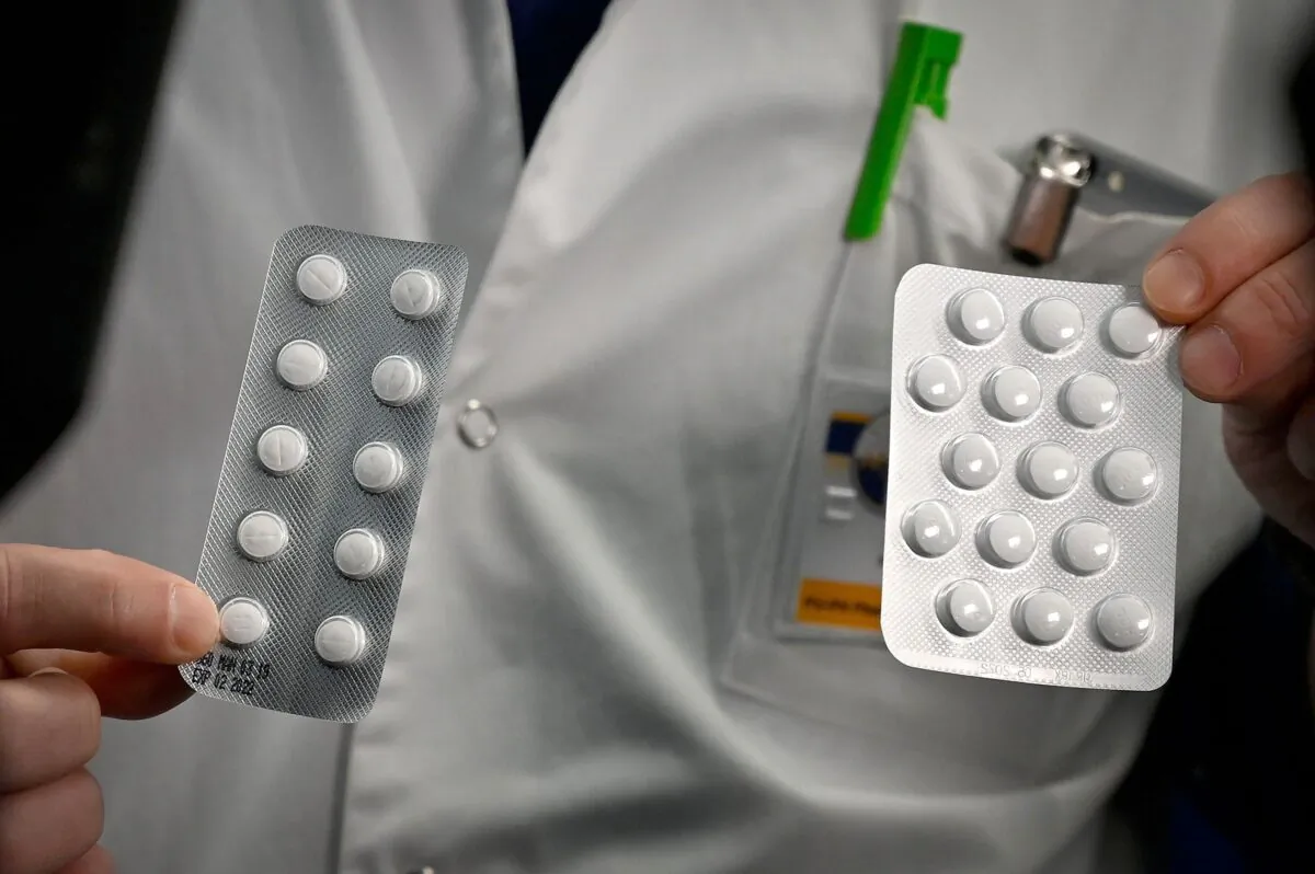 A medical staffer shows tablets containing chloroquine, one of the drugs being tested in Canada and other countries to treat COVID-19, in Marseille, France, on Feb. 26, 2020. A clinician-scientist in Toronto is leading a study on a drug used to treat HIV infection as a potential treatment for COVID-19. (Gerard Julien/AFP/Getty Images)