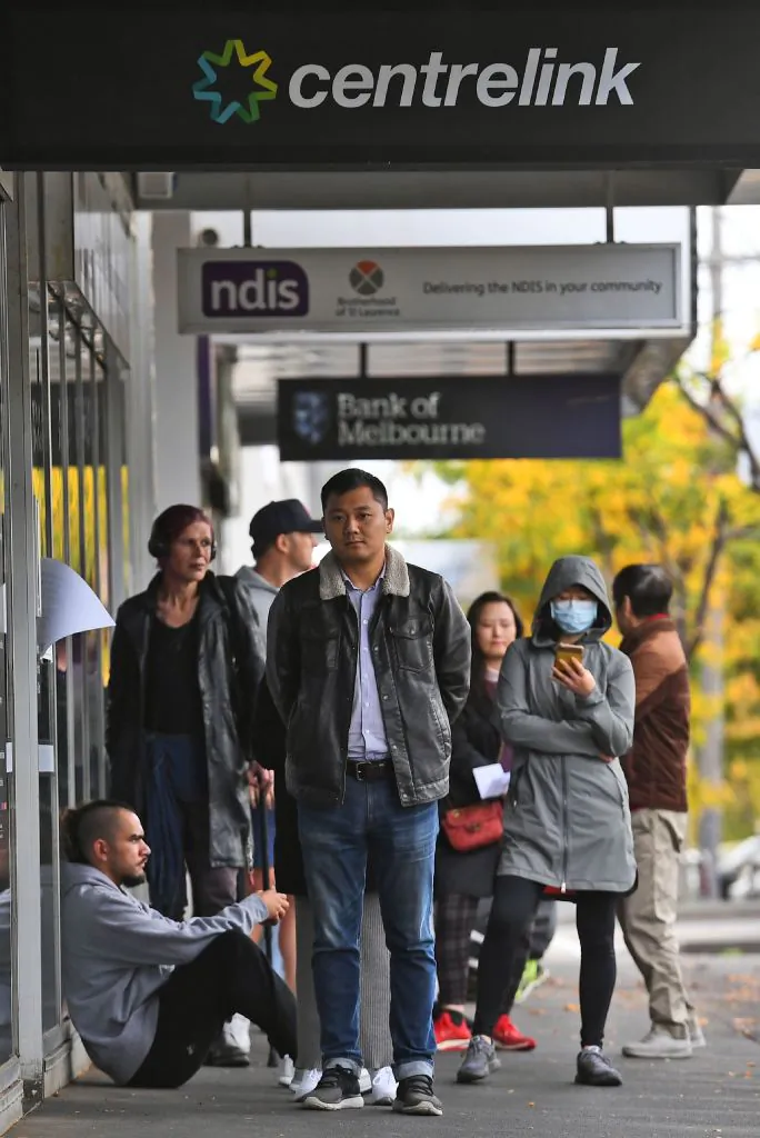 People queue up outside a Centrelink office in Melbourne, Australia, for welfare payments on April 20, 2020. (WILLIAM WEST/AFP via Getty Images)