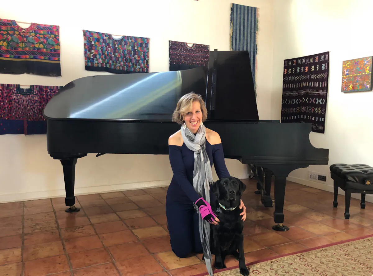 Professional pianist Lisa Spector with her black Labrador retriever, Gina. (Courtesy of Farha Akhtar)