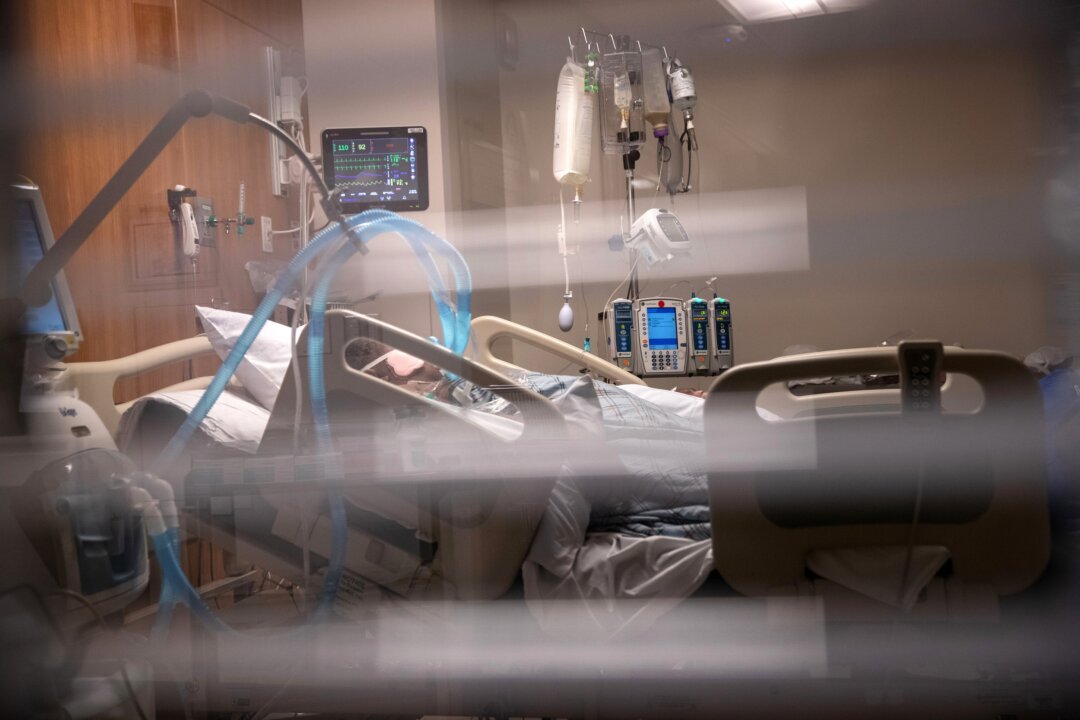 Breathing tubes hang next to a man with COVID-19 on a ventilator at a Stamford Hospital Intensive Care Unit in Stamford, Connecticut, on April 24, 2020. (John Moore/Getty Images)