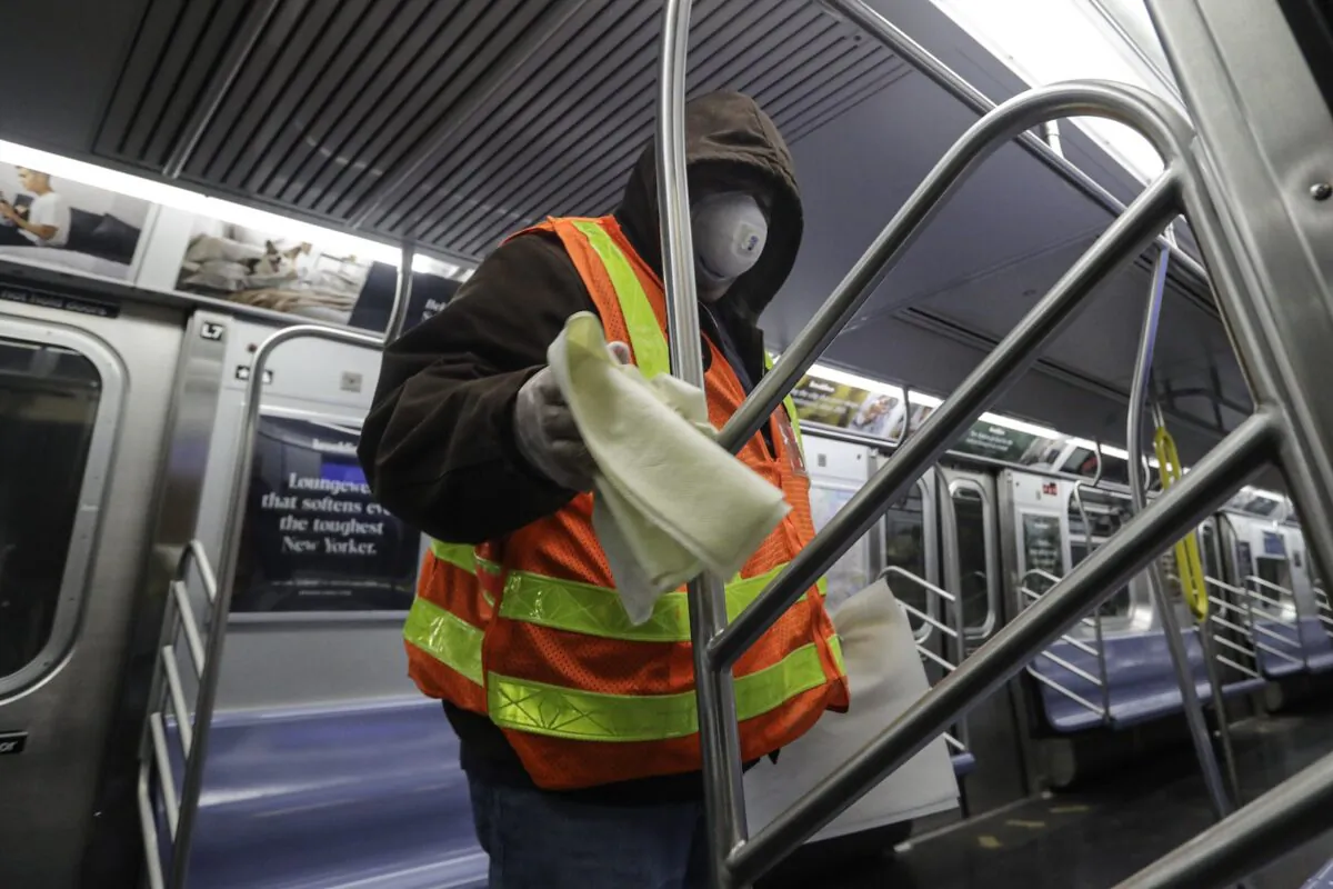 MTA officials work on trains for the disinfecting operations at the Coney Island Stillwell Avenue Terminal Wed., May 6, 2020, in the Brooklyn borough of New York. (Frank Franklin II/AP)