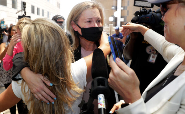 Salon owner Shelley Luther hugs supporters