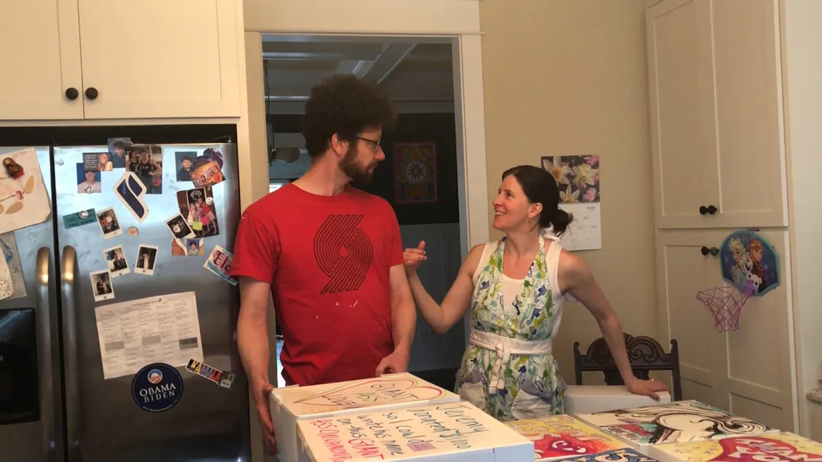 Whitney Rutz (R) and her husband, Paul, stand next to decorated boxes for large cinnamon rolls in their home in Portland, Ore. (Whitney Rutz via AP)