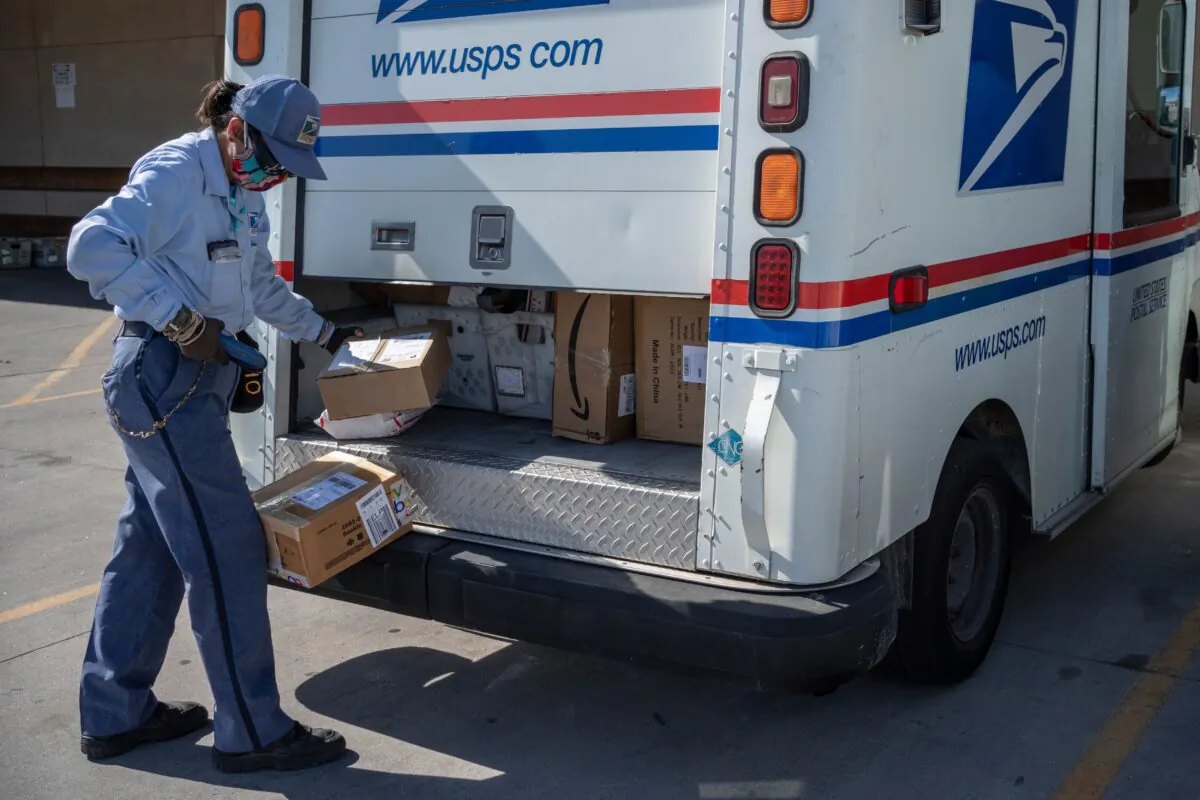 U.S. Postal Service mail carrier Lizette Portugal finishes loading her truck amid the COVID-19 pandemic in El Paso, Texas, on April 30, 2020. (Paul Ratje/AFP via Getty Images)