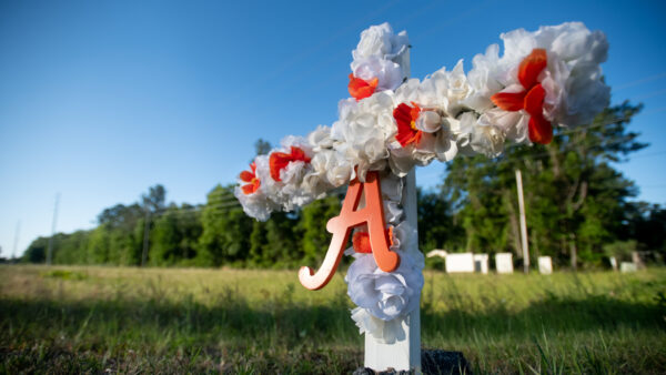A cross with flowers and a letter A