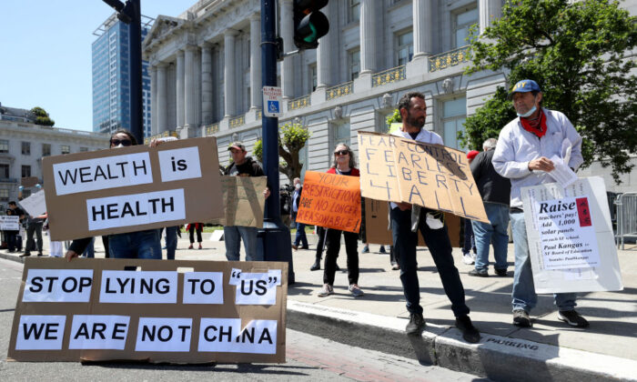 Demonstrators protest California Gov. Gavin Newsom's continued statewide shelter in place order outside of San Francisco City Hall in San Francisco, Calif., on May 1, 2020. (Justin Sullivan/Getty Images)
