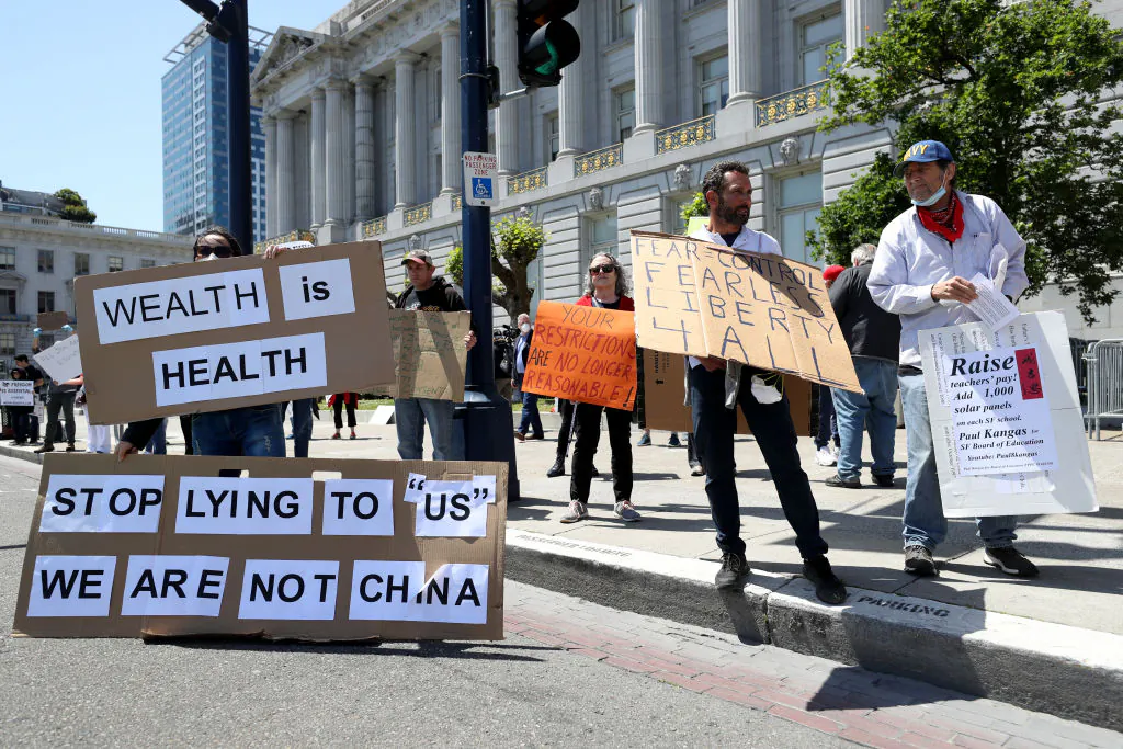 Demonstrators protest California Gov. Gavin Newsom's continued statewide shelter in place order outside of San Francisco City Hall in San Francisco, Calif., on May 1, 2020. (Justin Sullivan/Getty Images)