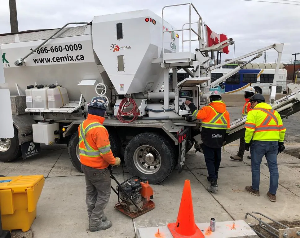 Workers get set to pour cement from a truck at the GO train station in Oakville, Ont., on Jan.28, 2020. (The Canadian Press/Richard Buchan)
