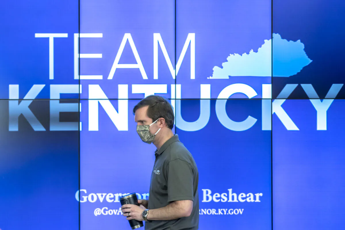 Kentucky Gov. Andy Beshear walks to the podium during a media conference at the state’s Emergency Operations Center at the Boone National Guard Center in Frankfort, Ky., to provide an update on the novel coronavirus on May 3, 2020. (Ryan C. Hermens/Lexington Herald-Leader via AP)