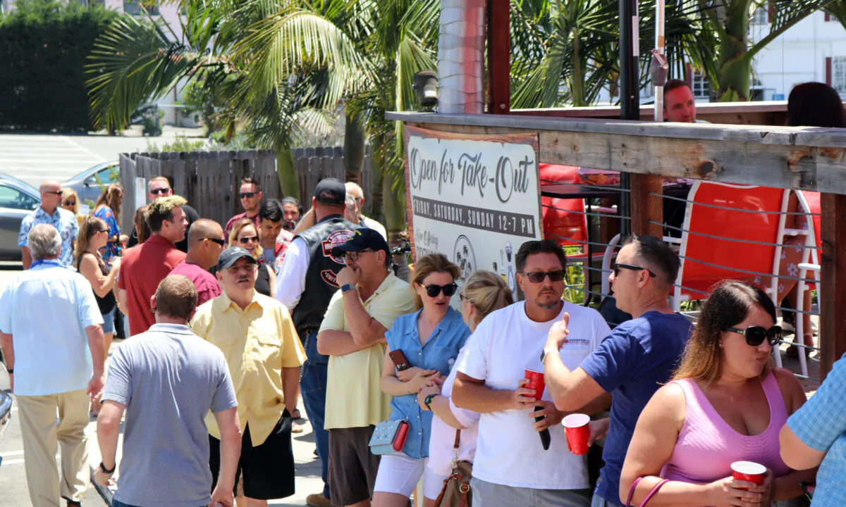 Customers wait in line to be seated at Nomads Canteen, which opened in defiance of Gov. Gavin Newsom's stay-at-home mandate, in San Clemente, Calif., on May 7, 2020. (Jamie Joseph/The Epoch Times)