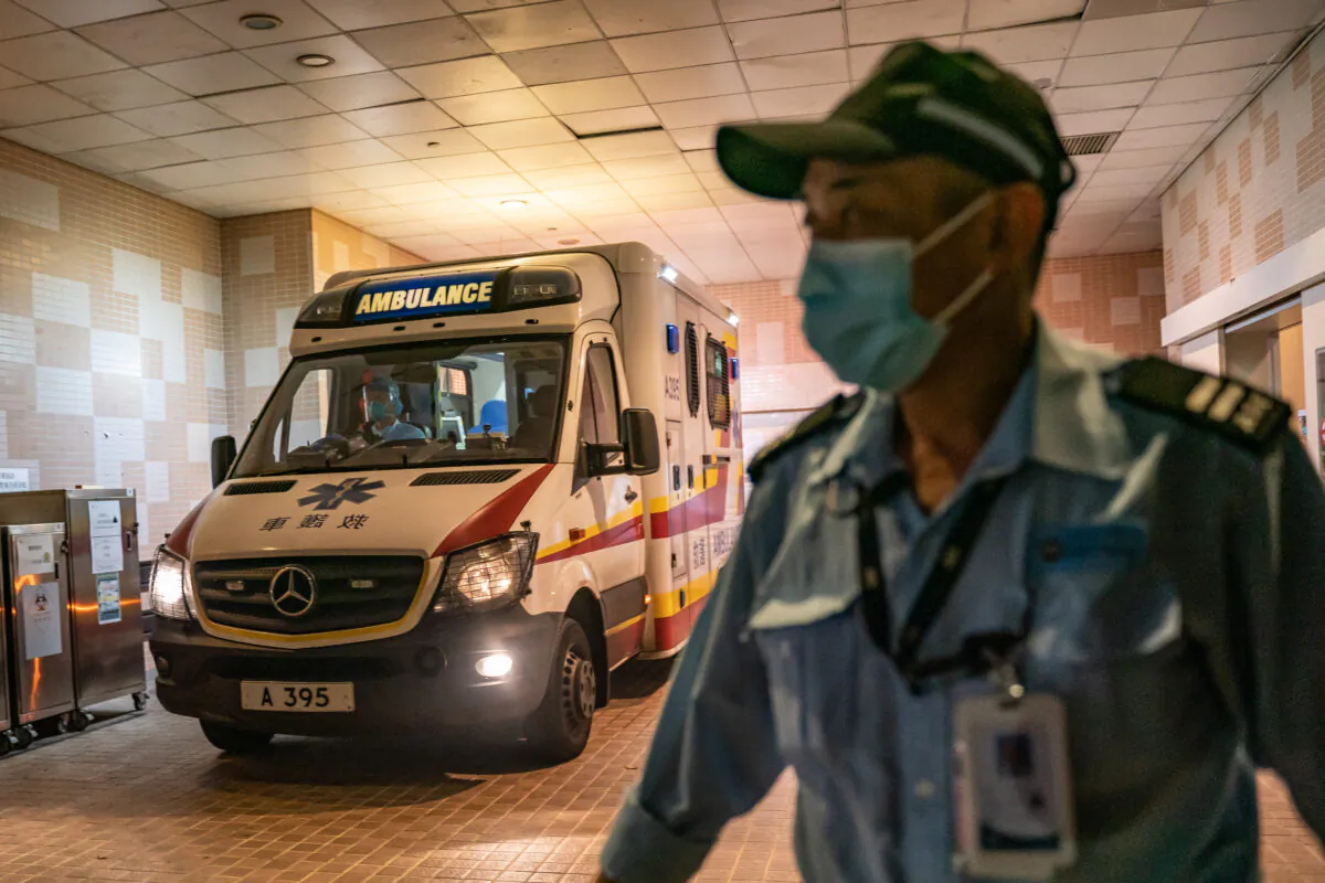 A security official stands guard as an ambulance arrives with a patient to the Infectious Disease Centre of Princess Margaret Hospital in Hong Kong on Jan. 22, 2020. (Anthony Kwan/Getty Images)