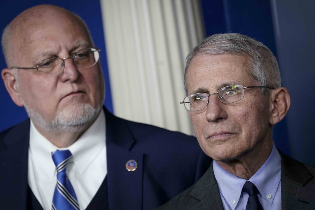 (L-R) Robert Redfield, director of the Centers for Disease Control and Prevention, and Dr. Anthony Fauci, director of the National Institute of Allergy and Infectious Diseases, attend a briefing on the administration's CCP virus response in the press briefing room of the White House in Washington on March 2, 2020. (Drew Angerer/Getty Images)