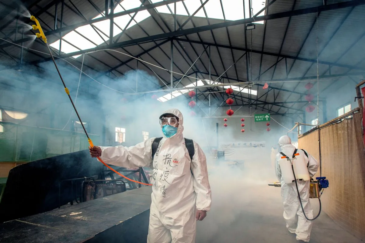 Staff are spraying disinfectant at a market in Suifenhe, Heilongjiang, China on May 6, 2020. (STR/AFP via Getty Images)