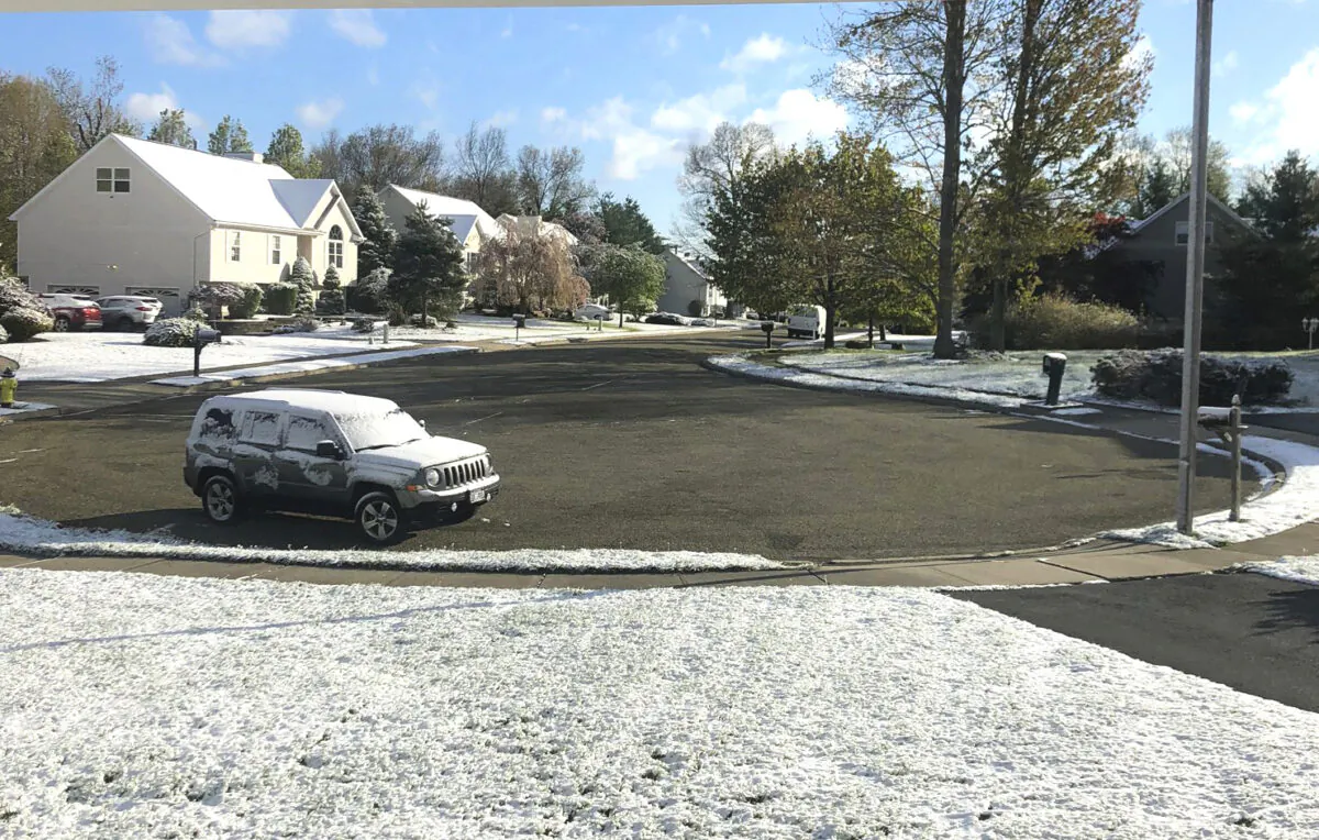 Snow accumulates on the grass and vehicles in Monroe, N.Y., on May 9, 2020. (Robert Beretta via AP)