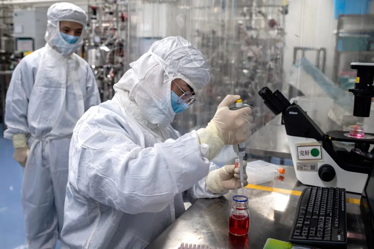 A worker tests an experimental vaccine for the COVID-19 at the Sinovac Biotech facilities in Beijing on April 29, 2020. (Nicolas Asfouri/AFP via Getty Images)