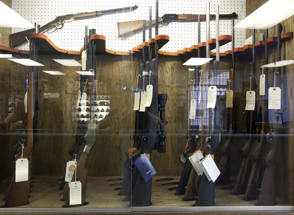 Hunting rifles on display in a glass case at a gun and rifle store in downtown Vancouver in a file photo. (The Canadian Press/Jonathan Hayward)
