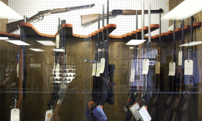 Hunting rifles on display in a glass case at a gun and rifle store in downtown Vancouver in a file photo. (The Canadian Press/Jonathan Hayward)