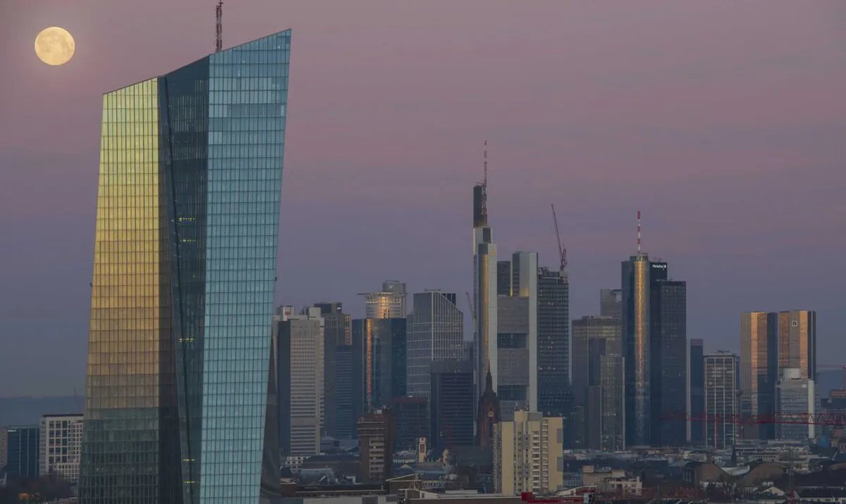Office buildings, including the corporate headquarters of the European Central Bank (ECB), Commerzbank and Deutsche Bank stand in the financial district in the city center lit by the full moon and the sunrise in Frankfurt, Germany, on March 21, 2019. (Thomas Lohnes/Getty Images)