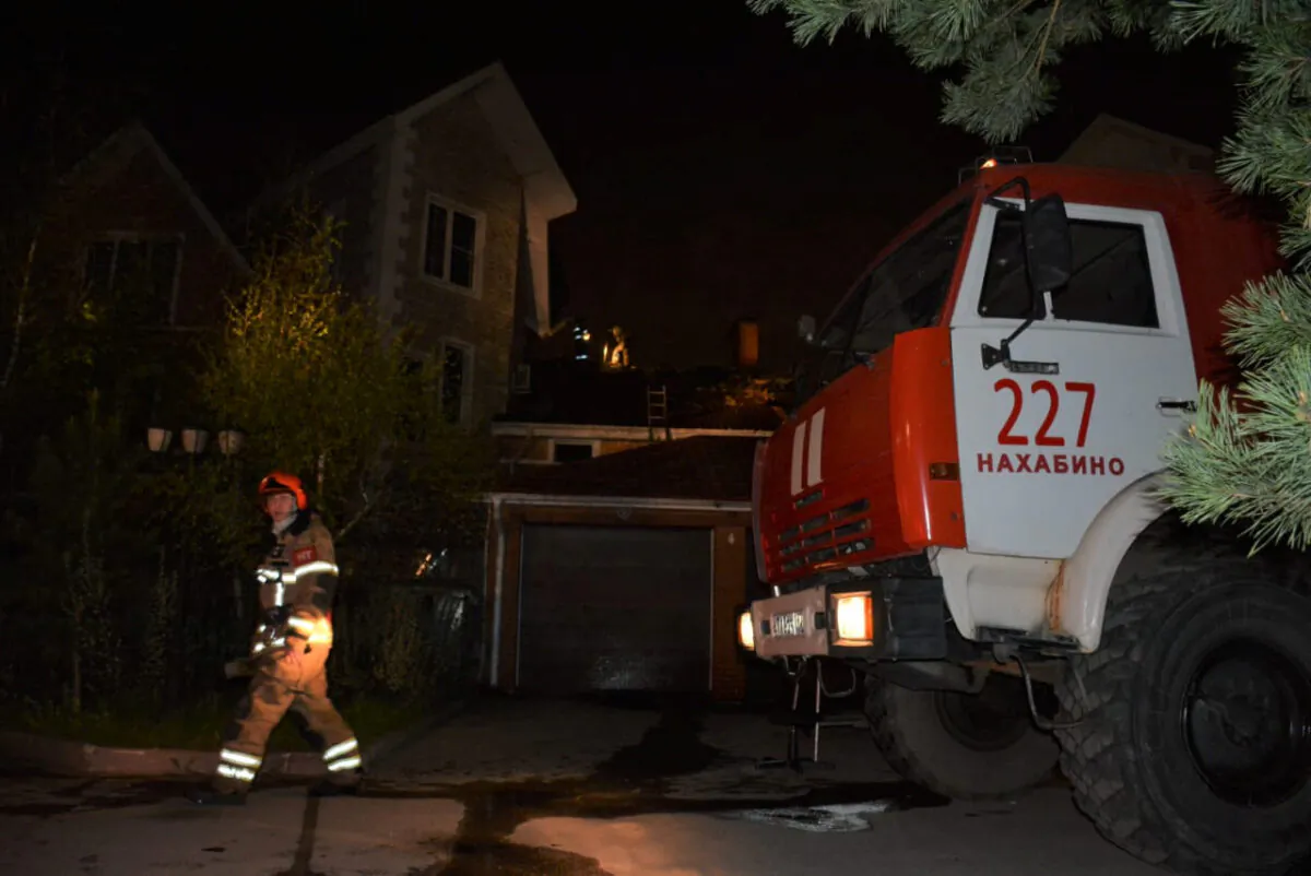 A firefighter walks past a private hospice after a fire killed nine elderly people in Krasnogorsk outside Moscow on May 11, 2020.  (Russian Emergency Situations Ministry/Handout via Reuters)
