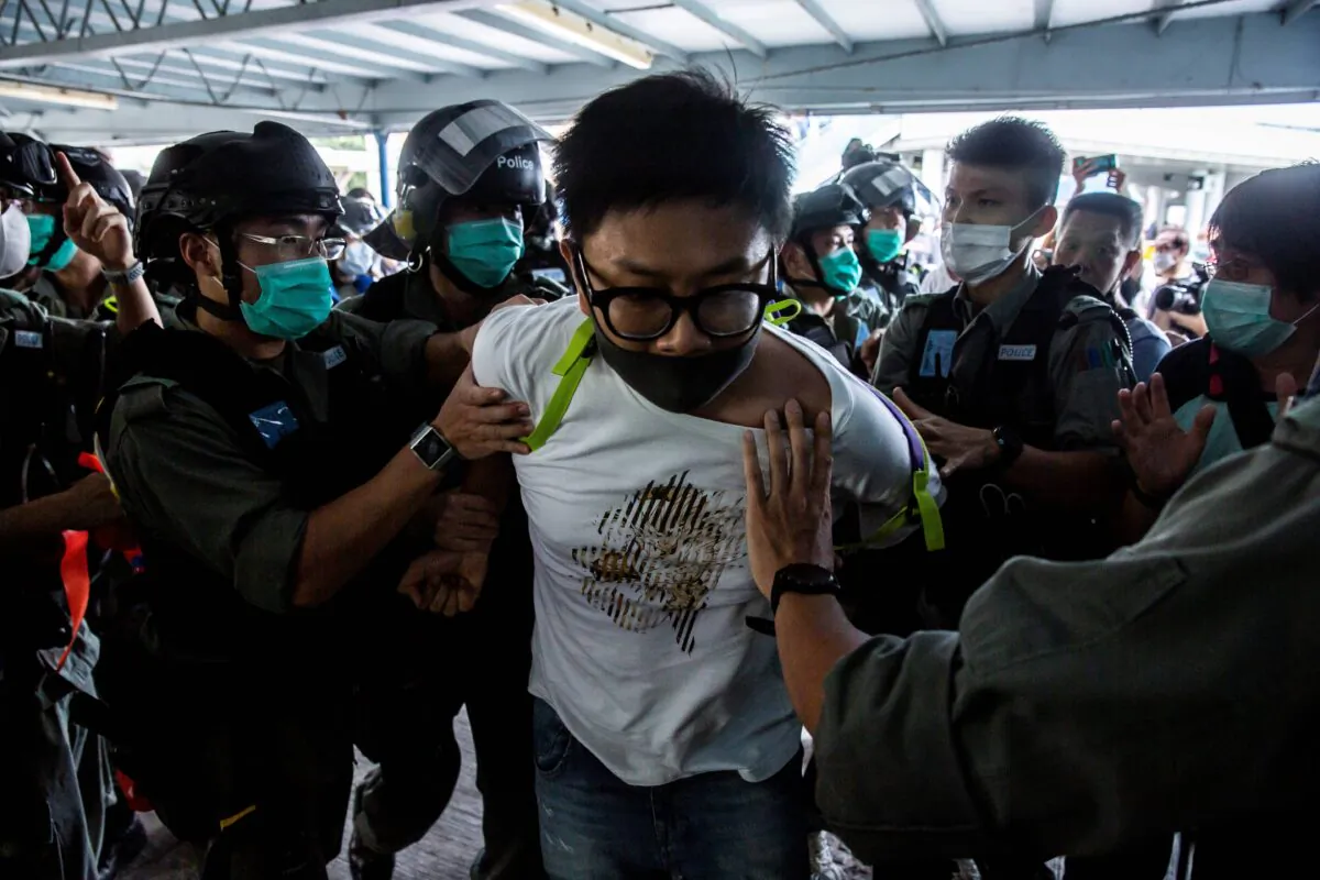 Police officers arrest a pro-democracy demonstrator (C) during a pro-democracy protest calling for the city's independence in Hong Kong on May 10, 2020. (Isaac Lawrence/AFP via Getty Images)